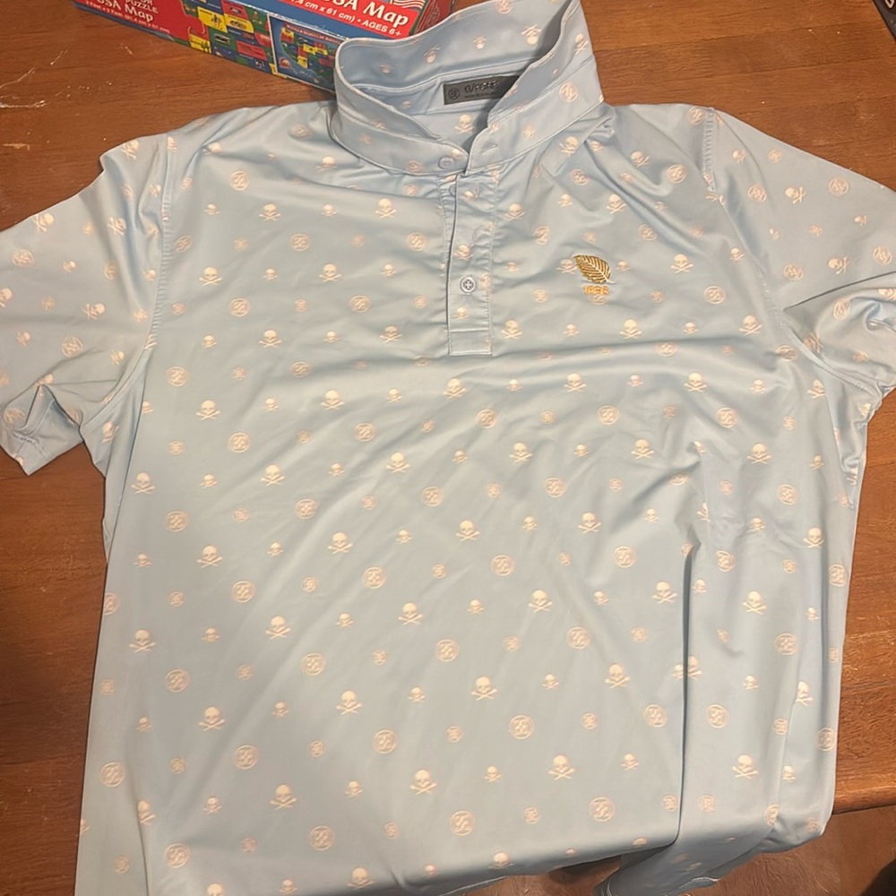 G/FORE Light Blue Polo with White Skull Motif